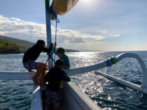 Kids on traditional Balinese boat on the Bali Sea in Amed.